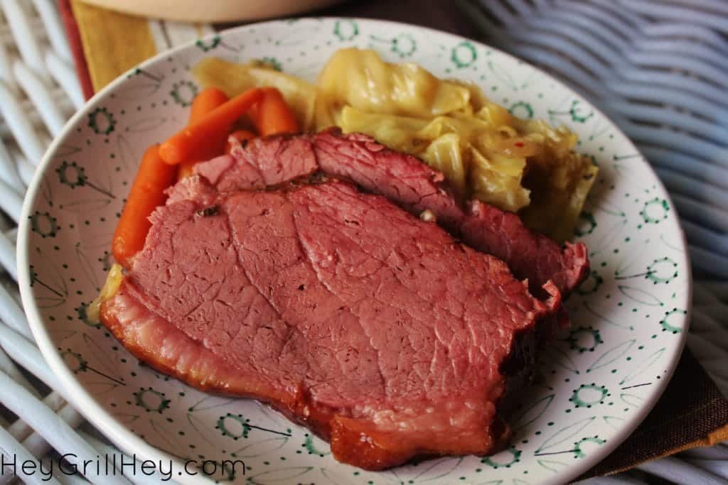 Smoked Corned Beef and Cabbage served on a white and blue plate.