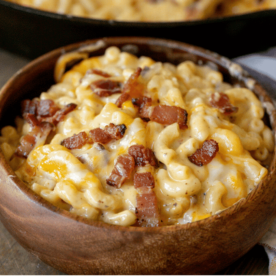 Bacon mac and cheese in a wooden bowl.