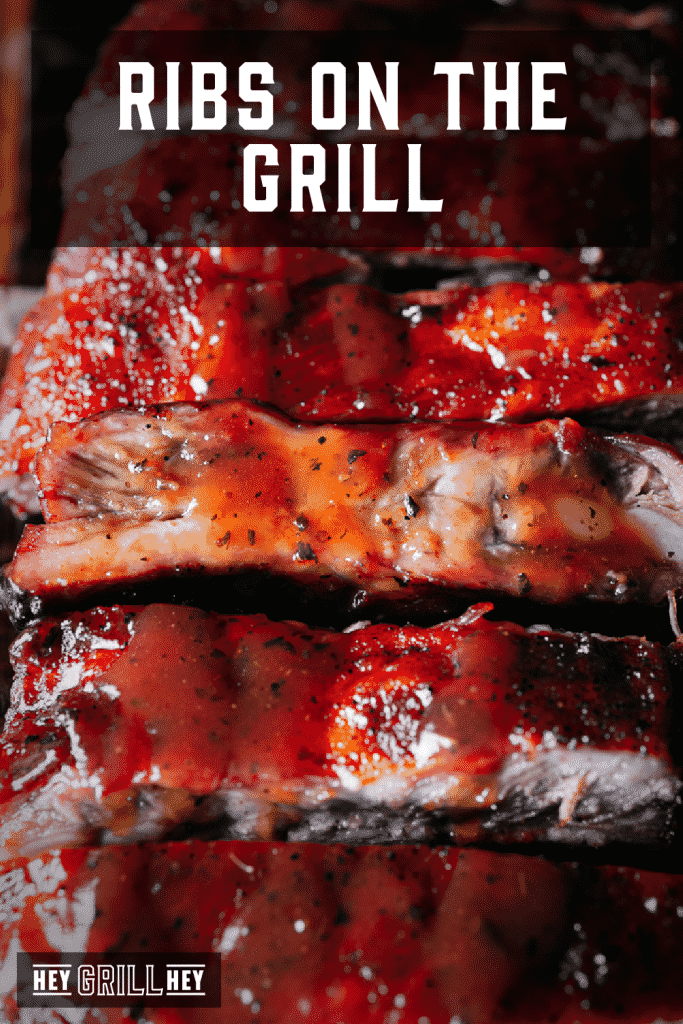 Sliced ribs stacked on a cutting board with text overlay - Ribs on the Grill.
