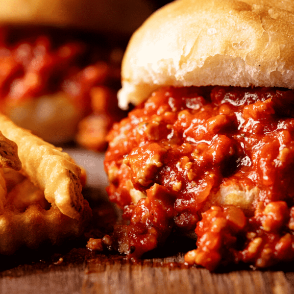 Turkey sloppy joes next to a pile of crinkle cut fries.