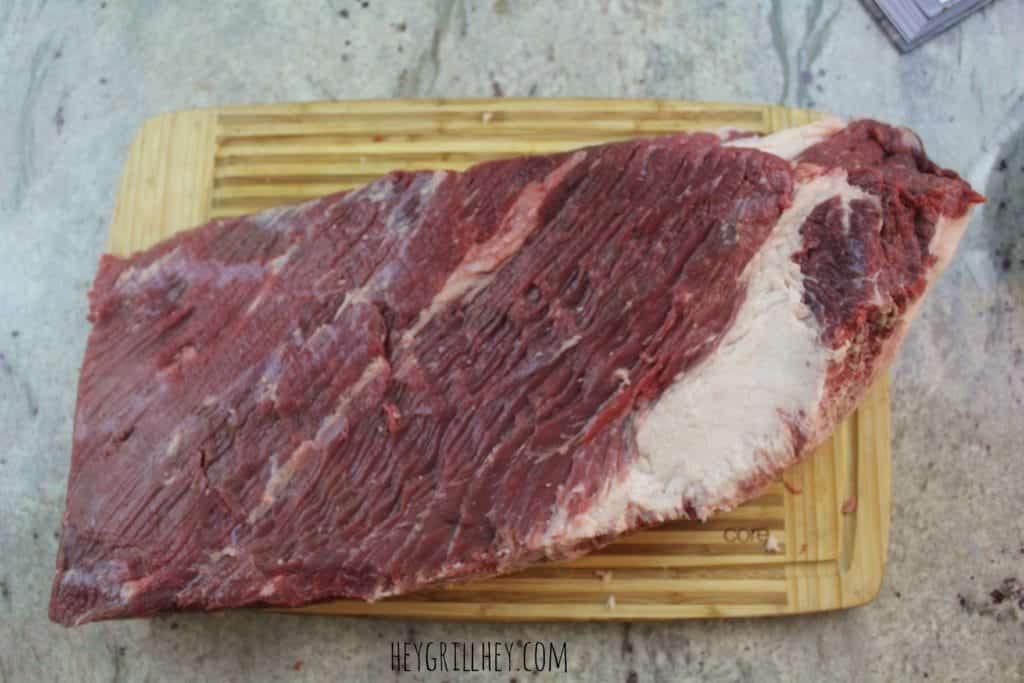 trimmed brisket on a wooden cutting board