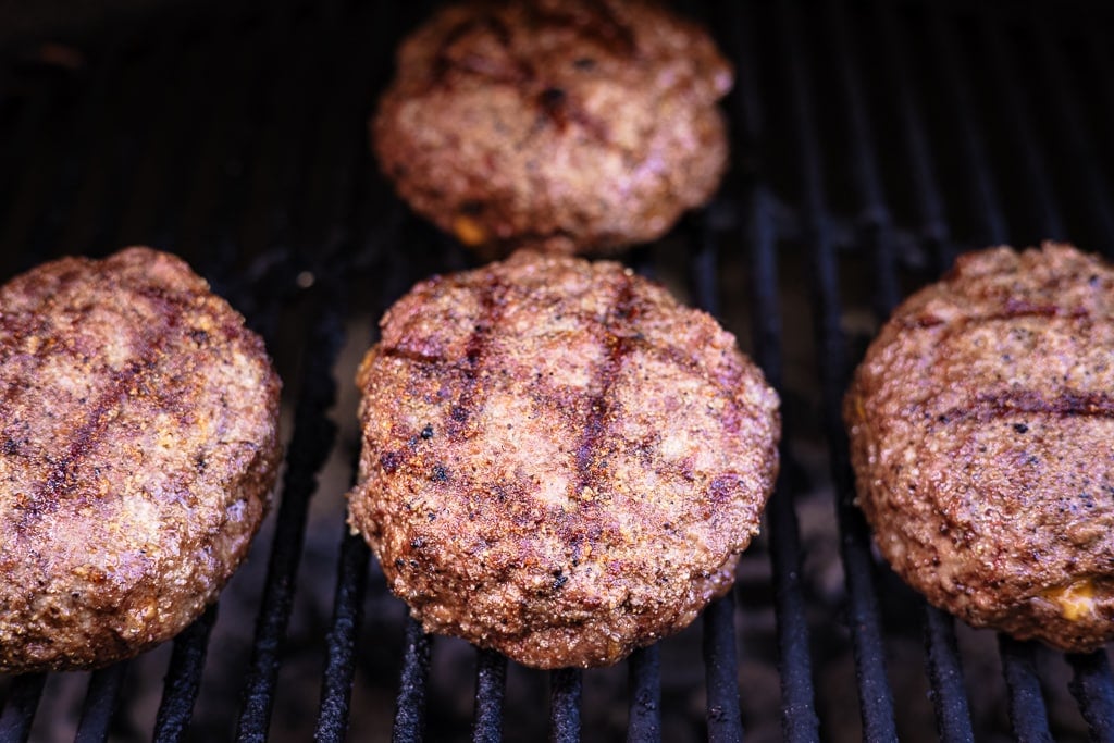 Mac and cheese stuffed burgers on the grill.