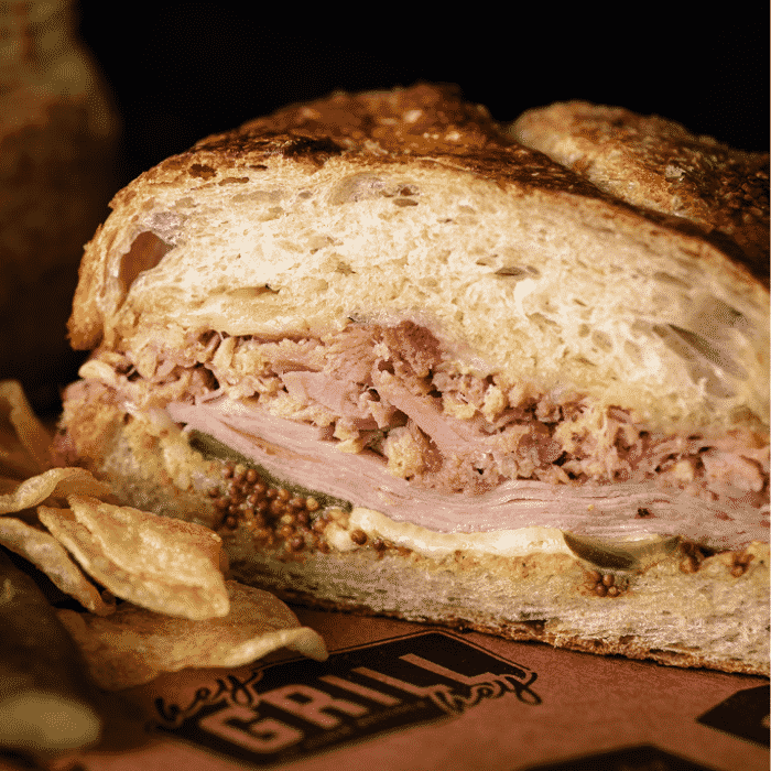A grilled sandwich on butcher paper.
