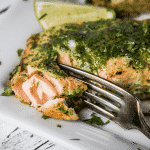 Fork flaking a grilled cilantro lime salmon fillet.