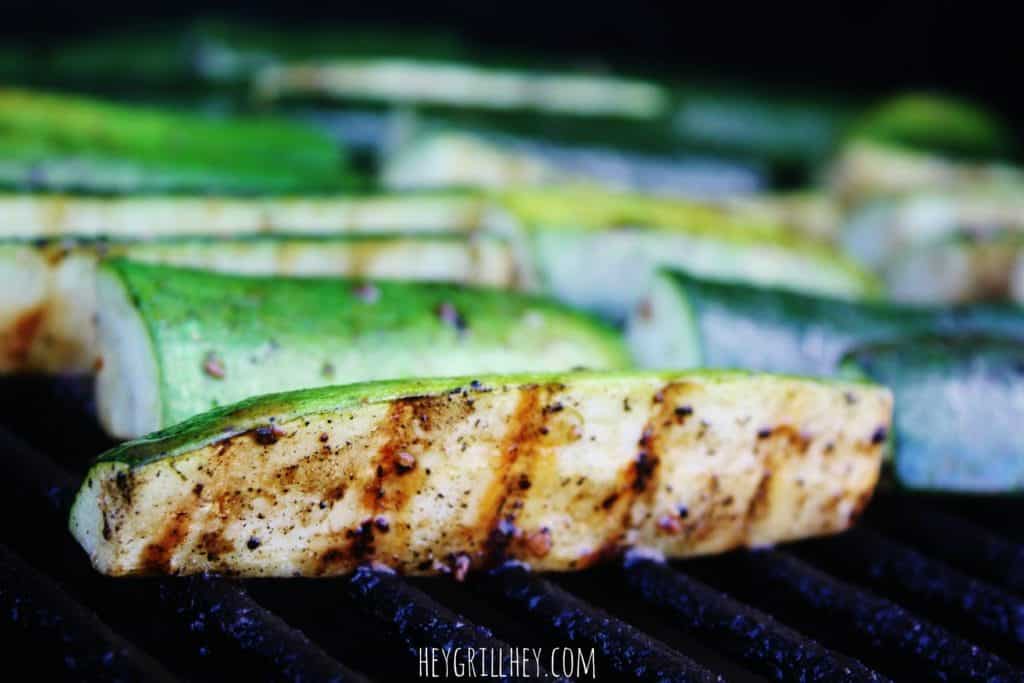 marinated zucchini slices on the grill.