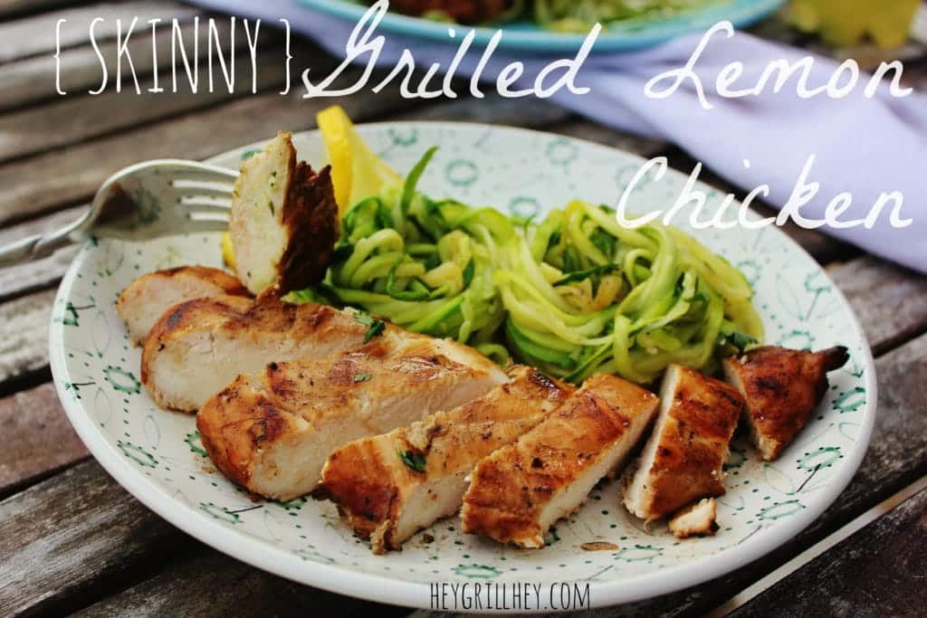 Sliced grilled chicken breasts on a white and blue plate with zucchini noodles