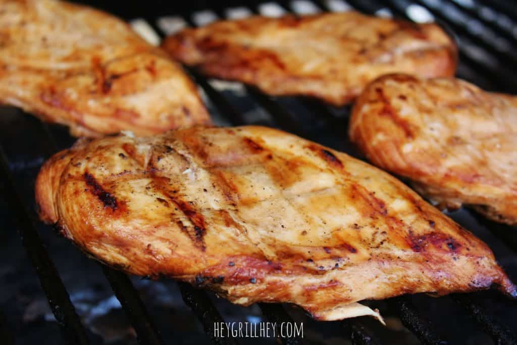 Marinated chicken cooking on a grill