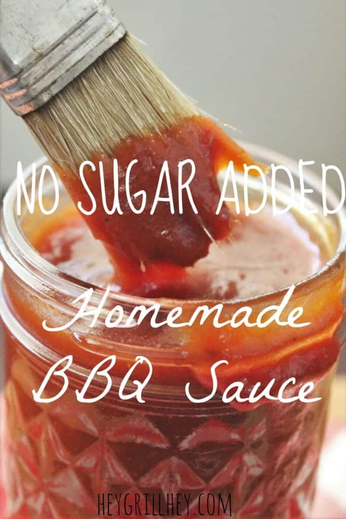 glass jar full of sauce with with a brush dipping in. Text overlay reads "No sugar added Homemade BBQ Sauce."