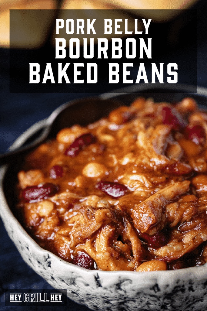 Bowl of pork belly bourbon baked beans with text overlay - Pork Belly Bourbon Baked Beans.