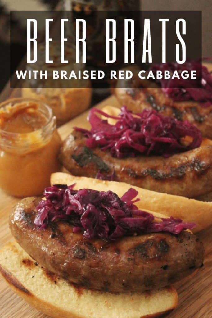 Grilled beer braised bratwursts with braised red cabbage on top.
