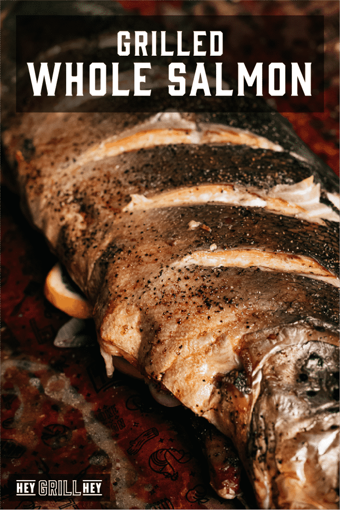 Grilled whole salmon on peach butcher paper with text overlay - Grilled Whole Salmon.
