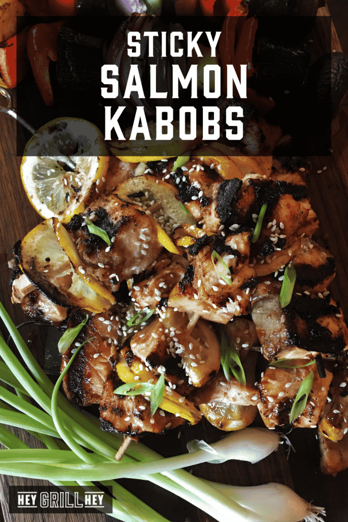 Salmon kabobs on a serving dish with text overlay - Sticky Salmon Kabobs.