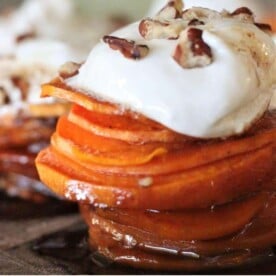 Candied sweet potato stack topped with marshmallow fluff and pecans.