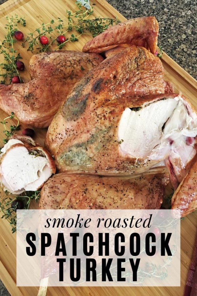 whole smoke roasted spatchcock turkey on a wooden cutting board