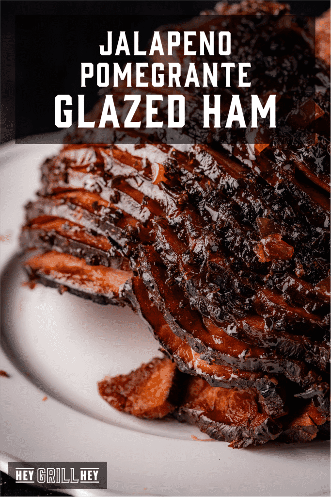 Jalapeno pomegranate smoked glazed ham on a serving platter with text overlay - Jalapeno Pomegranate Glazed Ham.