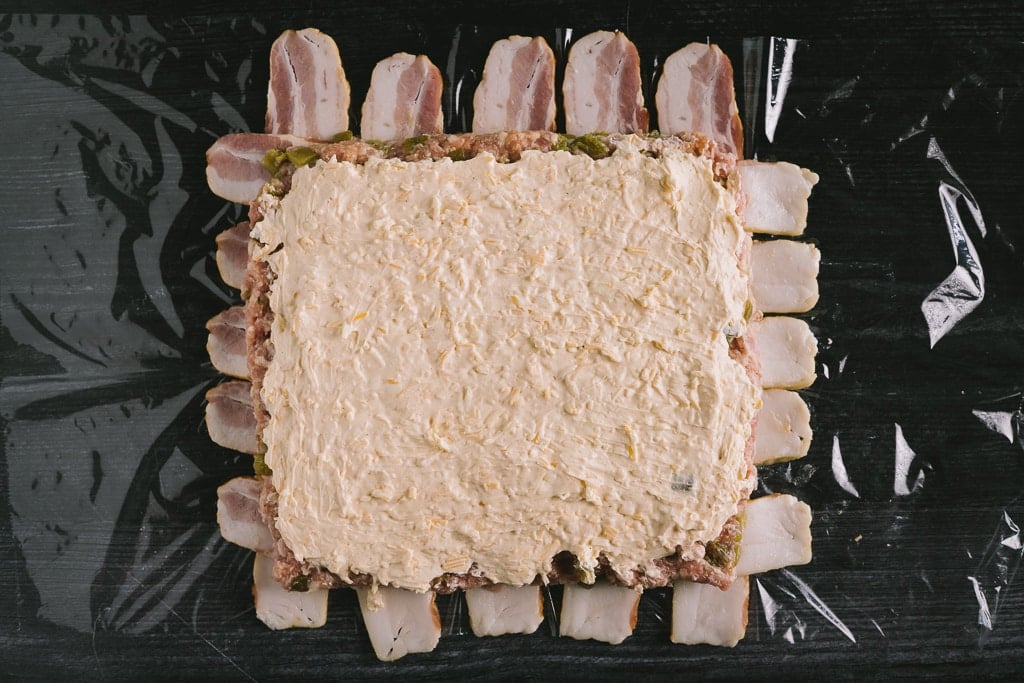 Bacon weave topped with sausage and cream cheese spread.