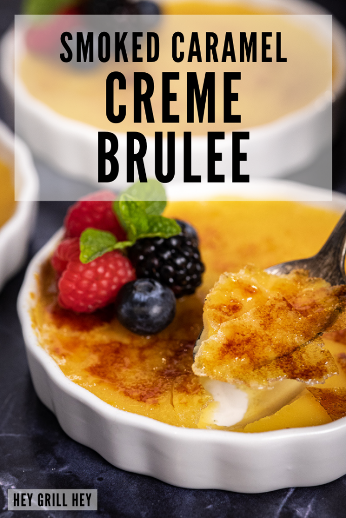 A spoon taking a scoop of caramel creme brulee out of a ramekin of creme brulee. Text overlay reads: smoked caramel creme brulee.