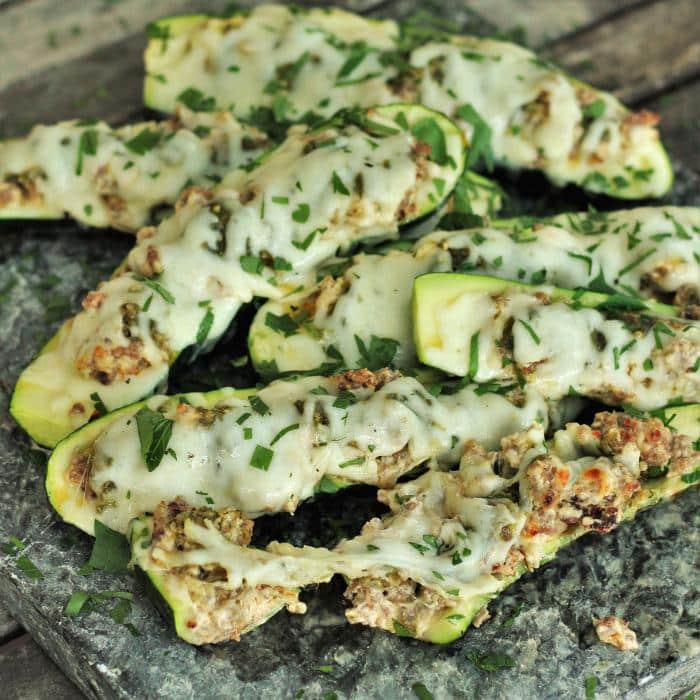 grilled zucchini boats on a wooden surface