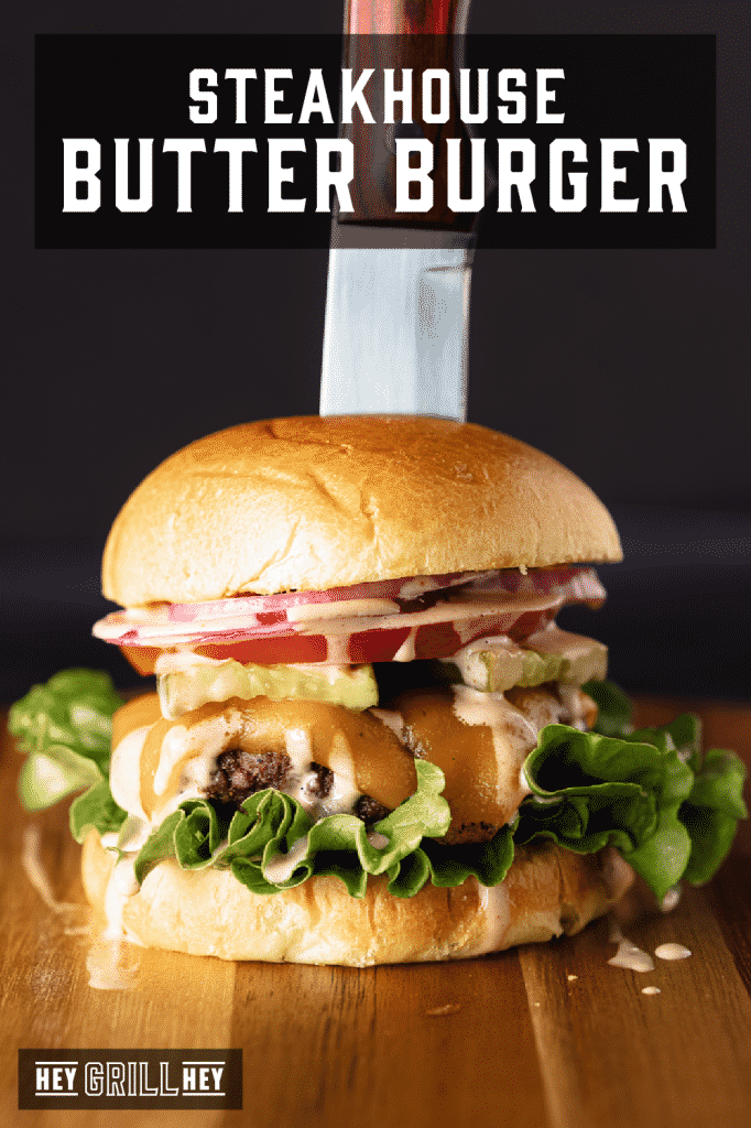 Chef's knife in a steakhouse butter burger with text overlay - steakhouse butter burger.