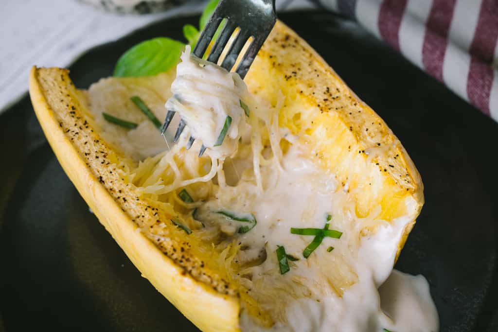 Grilled spaghetti squash topped with alfredo sauce.