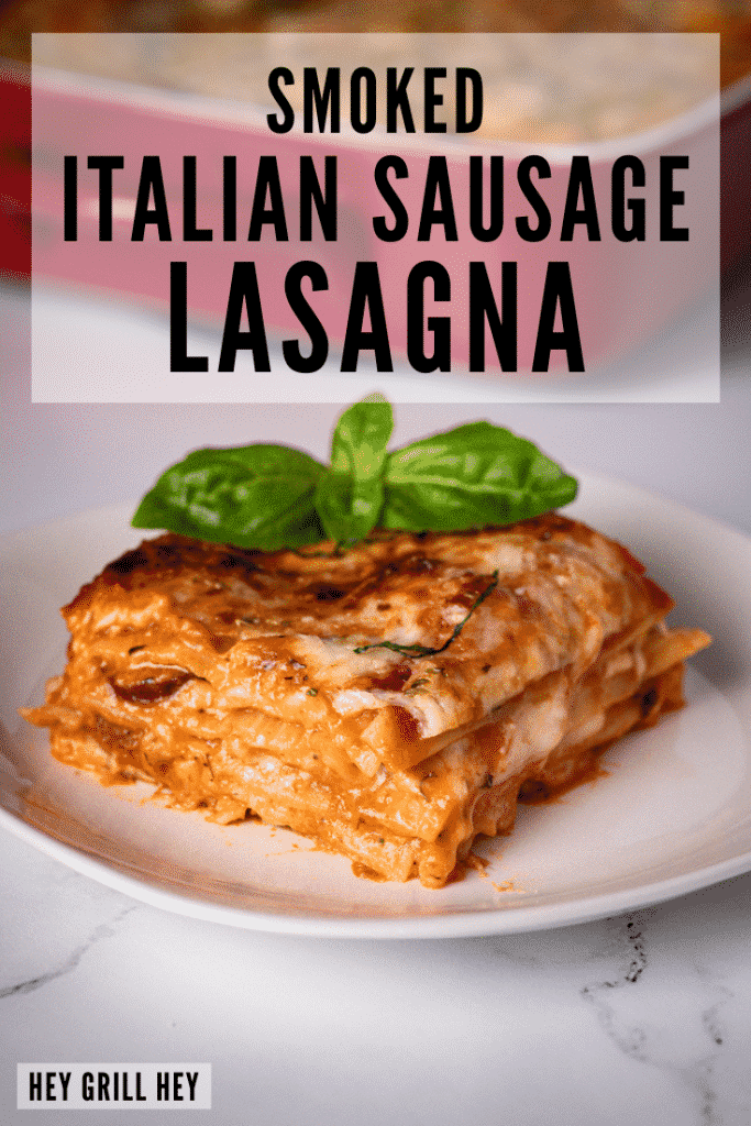 One slice of smoked Italian sausage lasagna on a white plate.