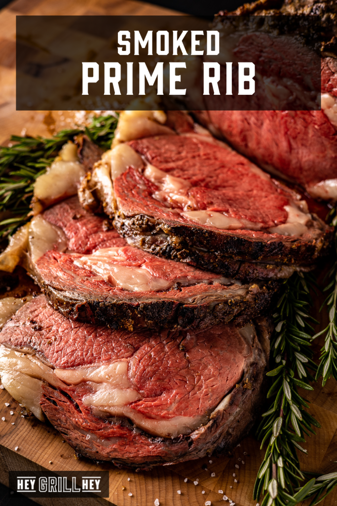 Sliced prime rib roast on a bed of fresh herbs with text overlay - Smoked Prime Rib.