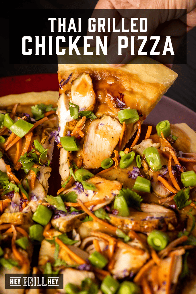 Slice of Thai grilled chicken pizza being pulled from the plate with text overlay - Thai Grilled Chicken Pizza.