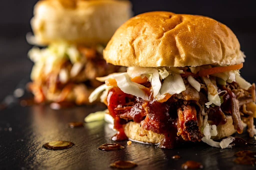 Pulled pork sandwiches on a serving platter.