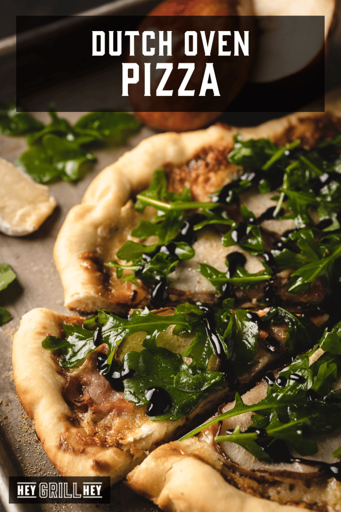 Dutch oven pizza topped with pear, brie, prosciutto, and arugula with text overlay - Dutch Oven Pizza.