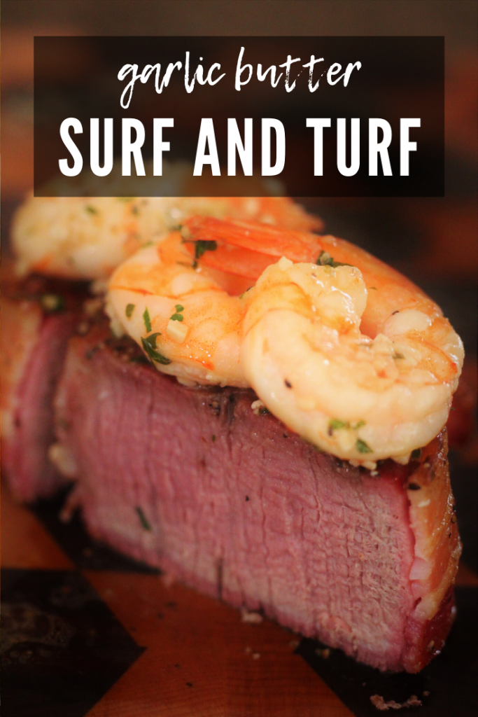 surf and turf on a wooden cutting board (grilled shrimp on top of filet mignon).