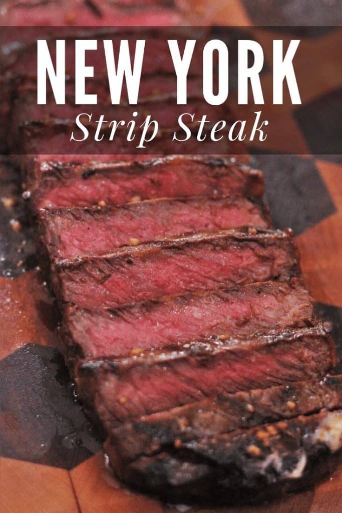 Sliced strip steak on a wood cutting board.