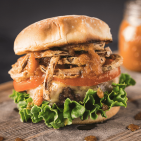 Bourbon burger topped with lettuce, tomato, crispy onion straws and bourbon BBQ sauce.