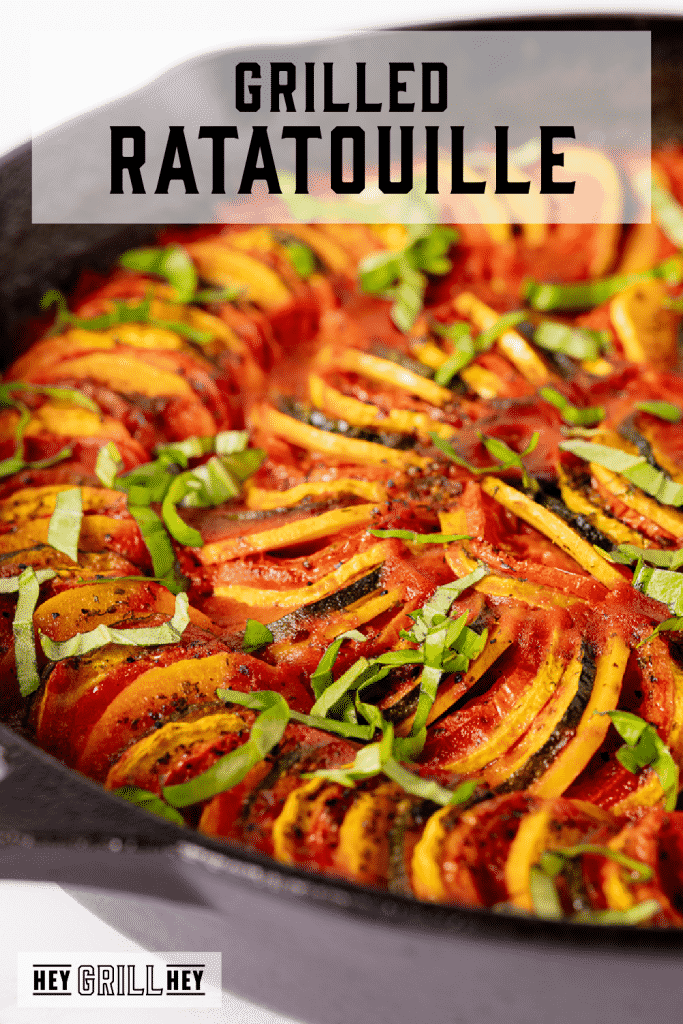 Grilled ratatouille in a cast iron skillet with text overlay - Grilled Ratatouille.