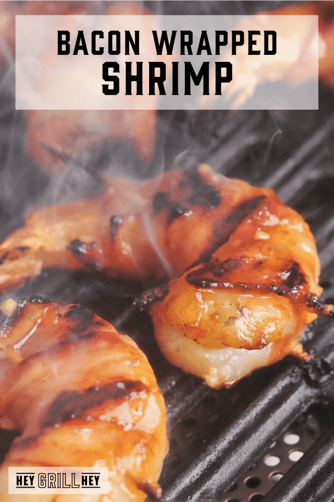 Bacon wrapped shrimp on the grill with text overlay - Bacon Wrapped Shrimp.