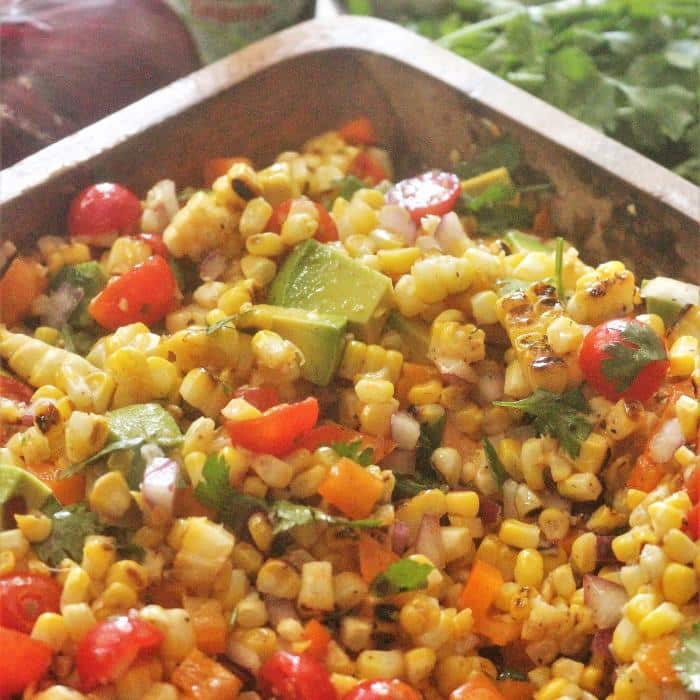 grilled corn salad in a wooden serving dish