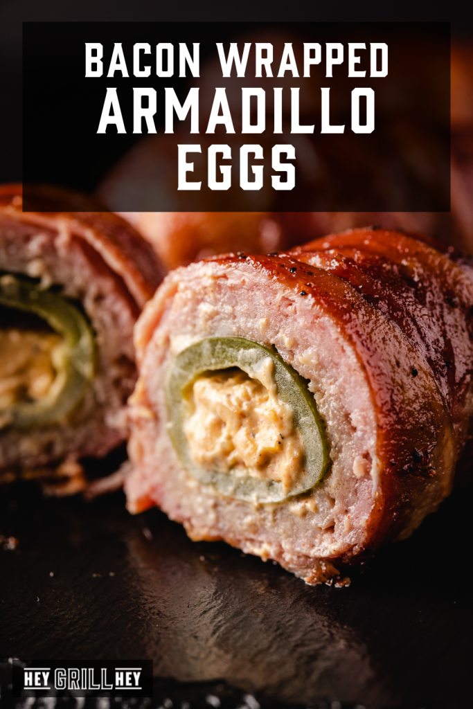 Sliced bacon wrapped armadillo egg on a serving platter with text overlay - Bacon Wrapped Armadillo Eggs.