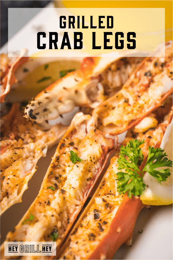 Grilled crab legs on a large white platter with text overlay - Grilled Crab Legs.