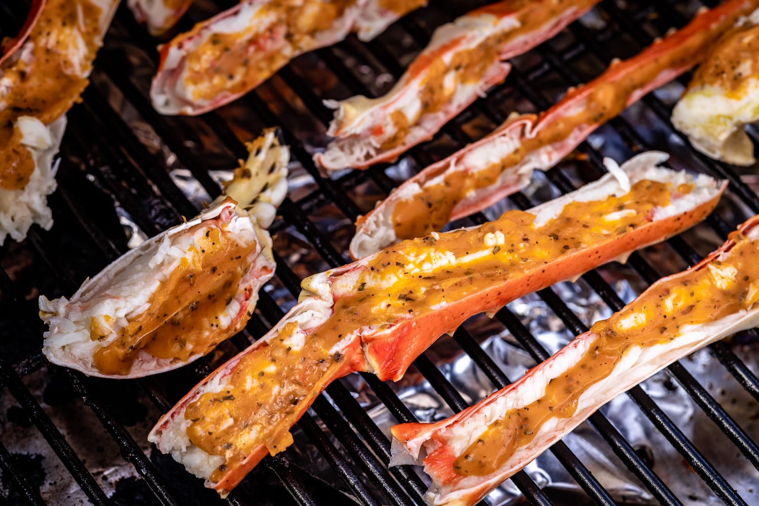 Seasoned king crab legs on the grill.
