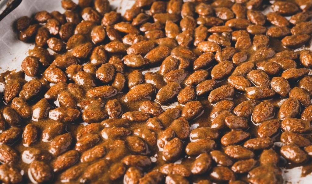 Cinnamon almonds on a baking sheet.