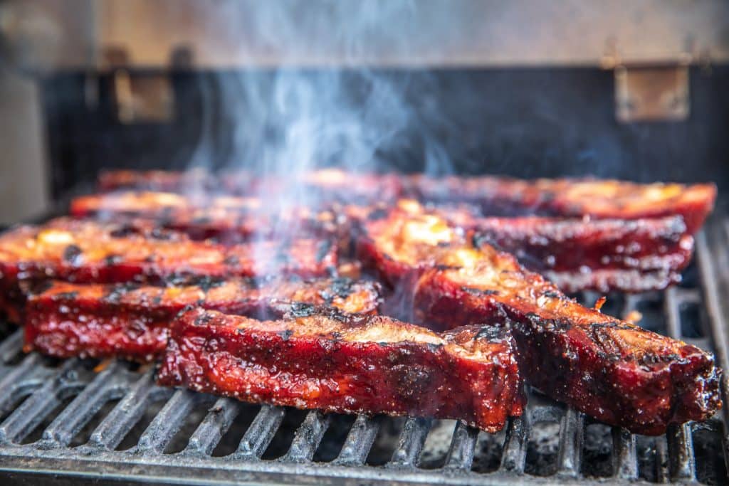smoky spare ribs on grill.