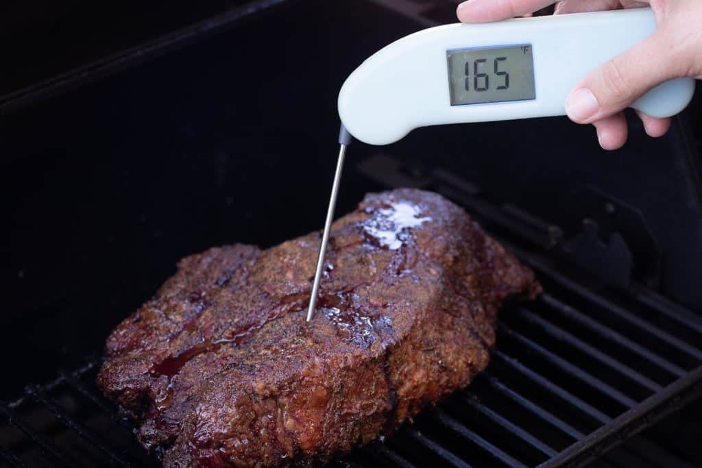 Chuck roast on the grill reading a temperature of 165 degrees F.