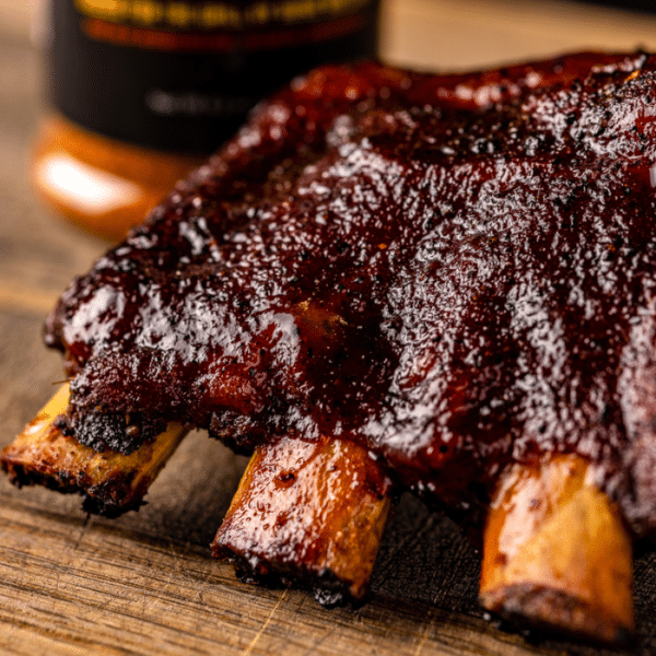 321 ribs on a wooden cutting board.