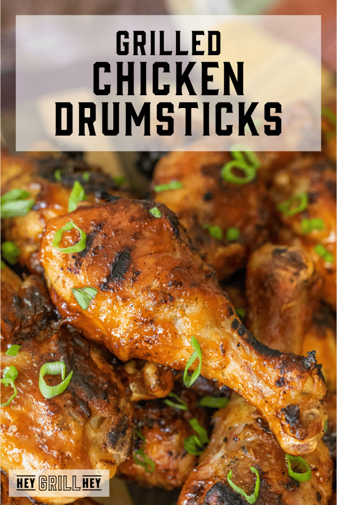 Pile of grilled chicken drumsticks with text overlay - Grilled Chicken Drumsticks.