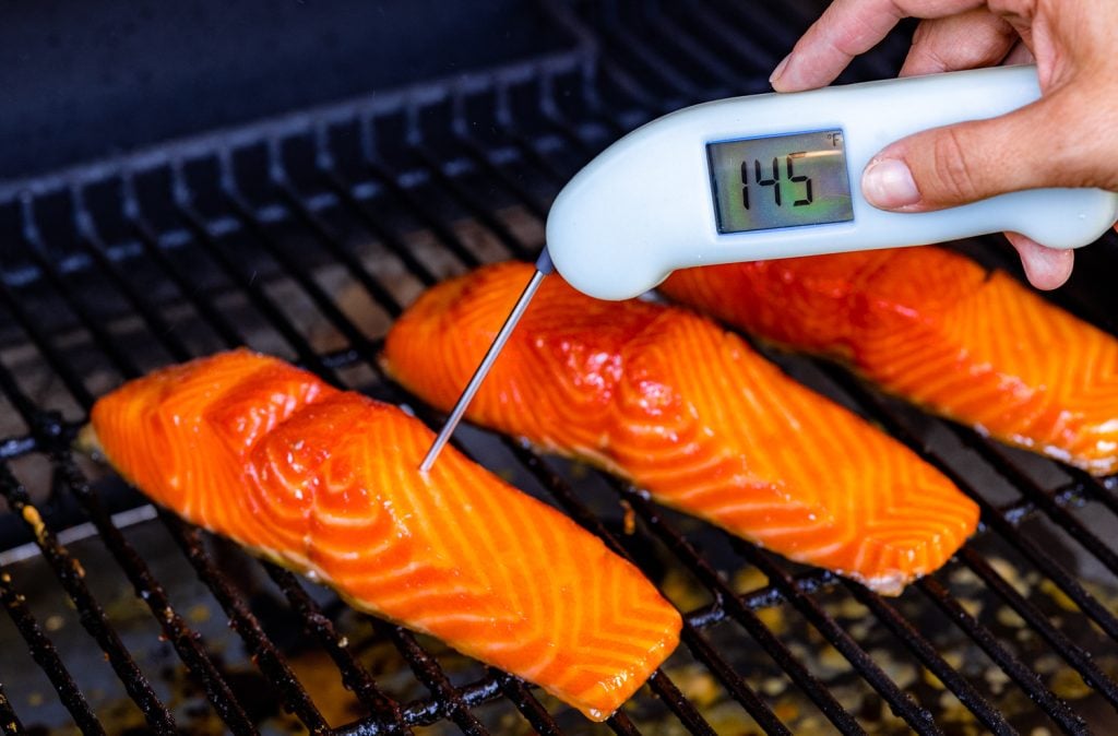 Salmon on the smoker reading a temperature of 145 degrees F.