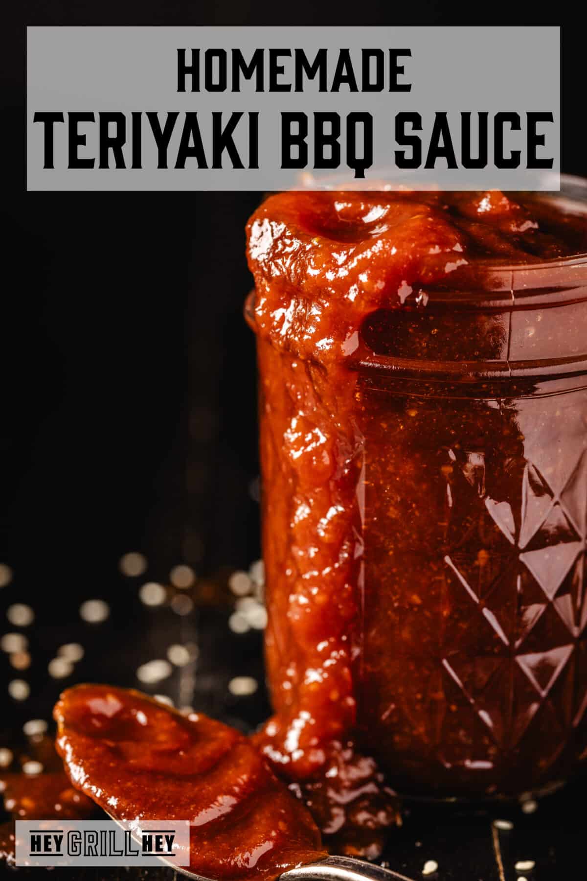 A jar of red BBQ sauce overflowing onto a countertop. The text overlay reads "Homemade Teriyaki BBQ Sauce" at the top, and "Hey Grill Hey" at the bottom.