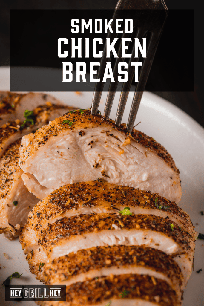 Sliced smoked chicken breast on a fork with text overlay - Smoked Chicken Breast.