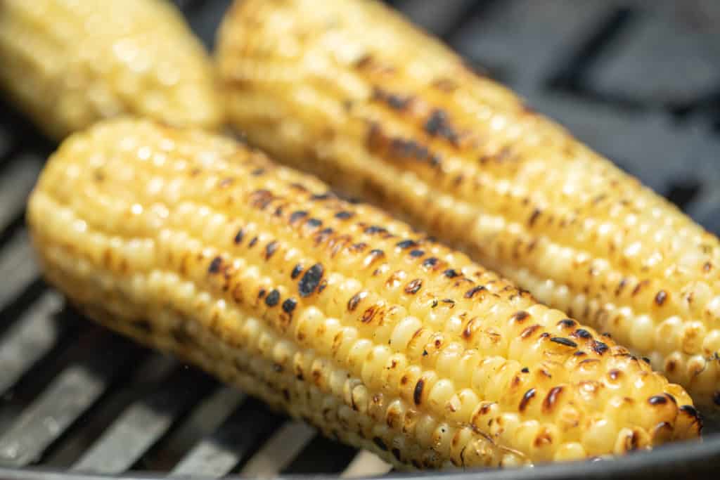 grilled yellow corn on grill grates