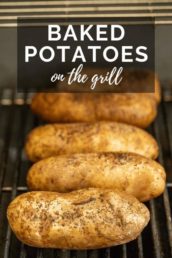 whole baked potatoes on a grill