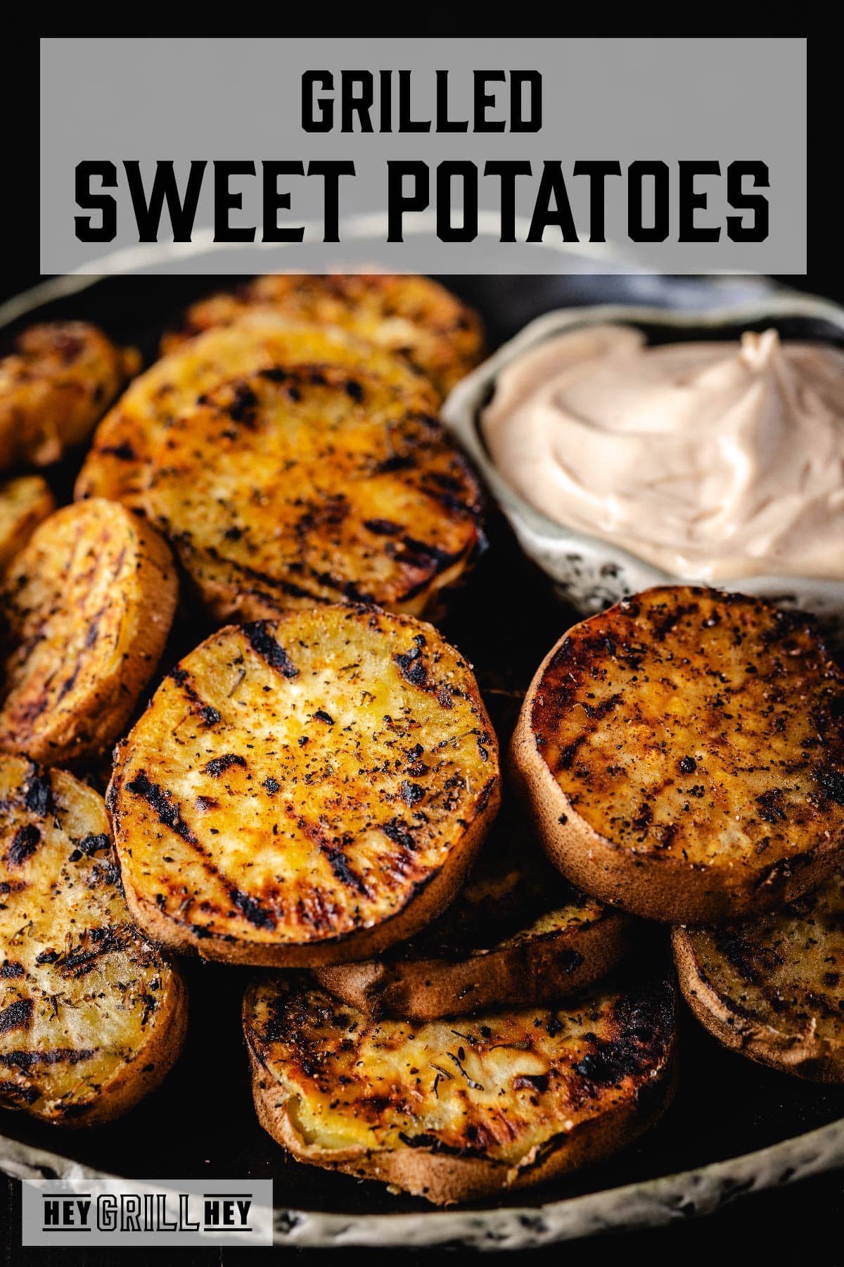 A plate of grilled potato slices and a bowl of dip. The text overlay reads "Grilled Sweet Potatoes" at the top, and "Hey Grill Hey" at the bottom.