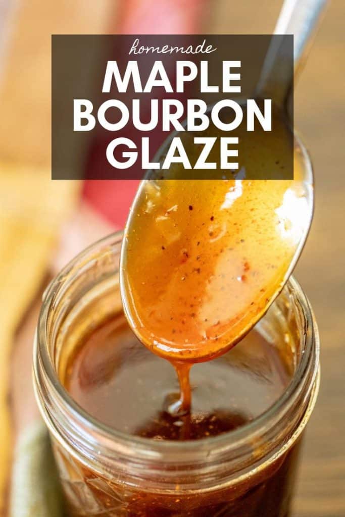 Maple bourbon glaze in a glass jar with spoon.